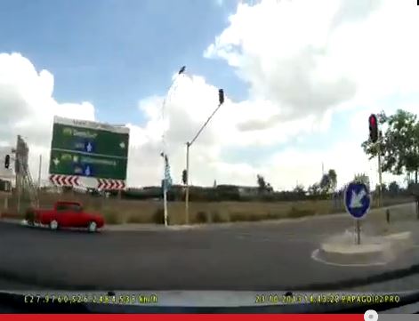 Video captures driver in little red car driving across red traffic ...