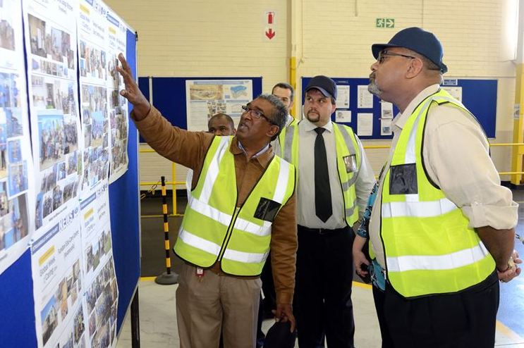 Basil Raman, Operations Manager of the Ford Struandale Engine Plant (left) and John Cameron, Plant Manager (middle), discuss some of the local community projects undertaken by the employees with US Consul General Teddy Taylor during a tour of the Struandale Engine Plant.