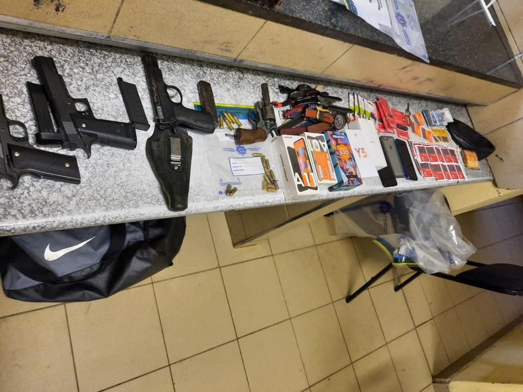 Suspect in custody following discovery of illegal firearms and stolen property