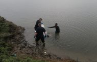 Police divers retrieve a missing man's body from Vaal River