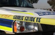Suspect killed during business robbery whilst another was arrested, manhunt launched for third suspect.
